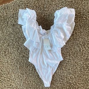 White ruffled sleeve body suit